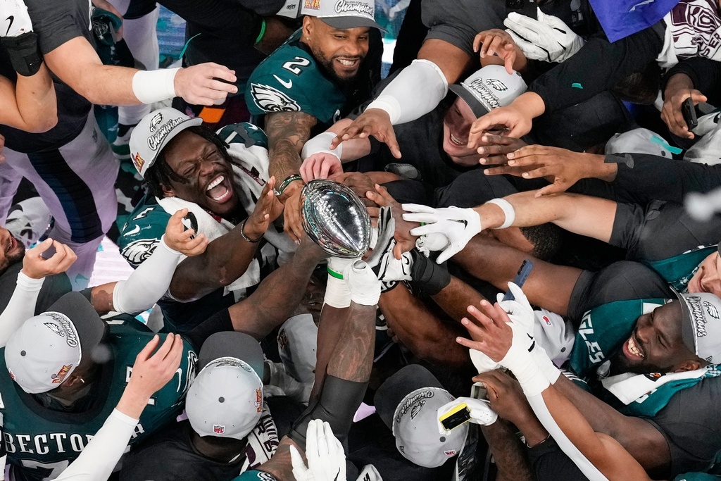 Philadelphia Eagles players celebrate with the Vince Lombardi Trophy after the Eagles won the NFL Super Bowl 59 football game against the Kansas City Chiefs, Feb. 9, 2025, in New Orleans. (AP Photo/David J. Phillip, File)