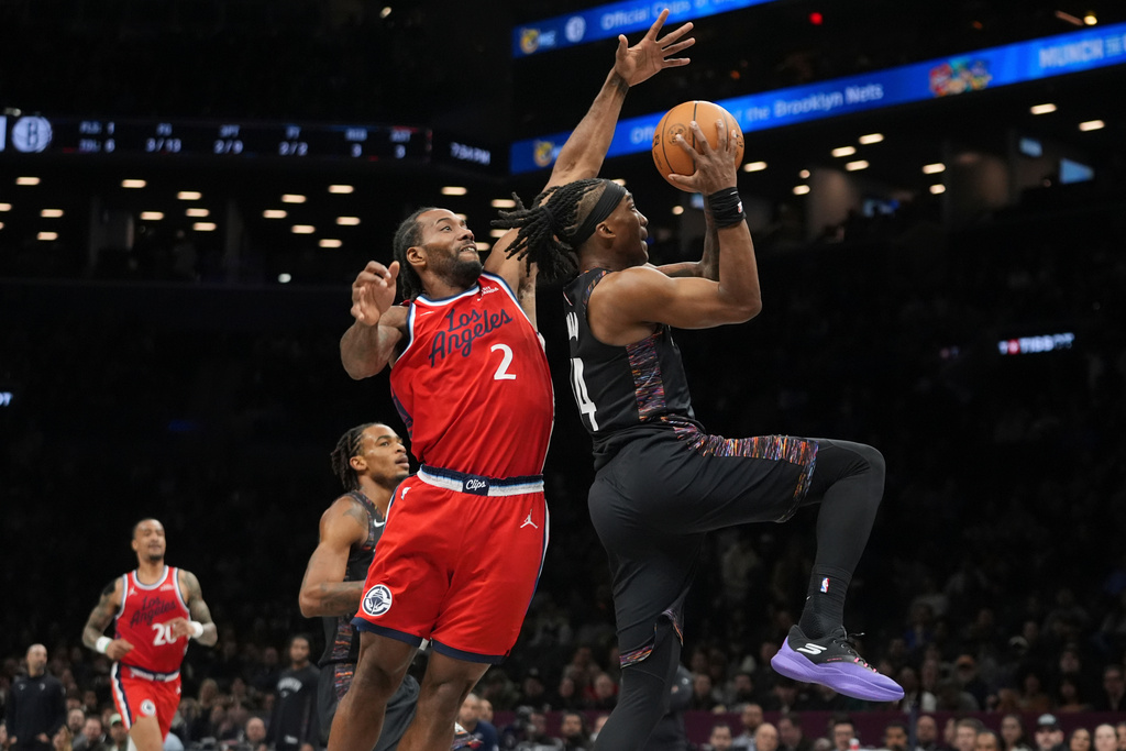 Brooklyn Nets' Terance Mann, right, drives past LA Clippers' Kawhi Leonard during the first half of an NBA basketball game Friday, Jan. 9, 2026, in New York. (AP Photo/Frank Franklin II)