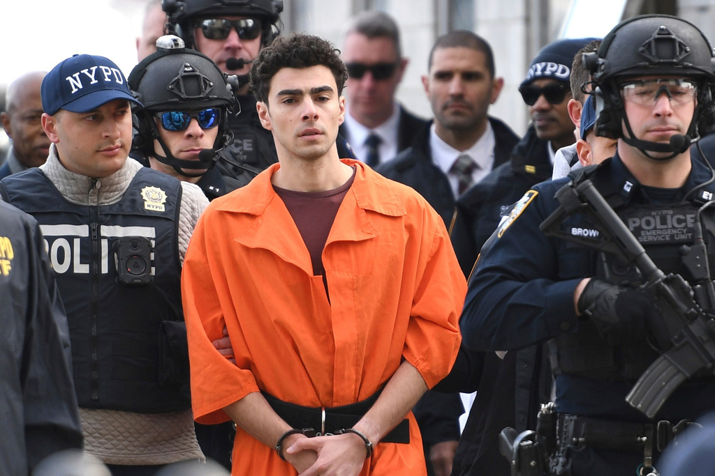 FILE - Luigi Mangione, a suspect in the fatal shooting of UnitedHealthcare CEO Brian Thompson, is escorted by police, Thursday, Dec. 19, 2024, in New York. (AP Photo/Pamela Smith, File)
