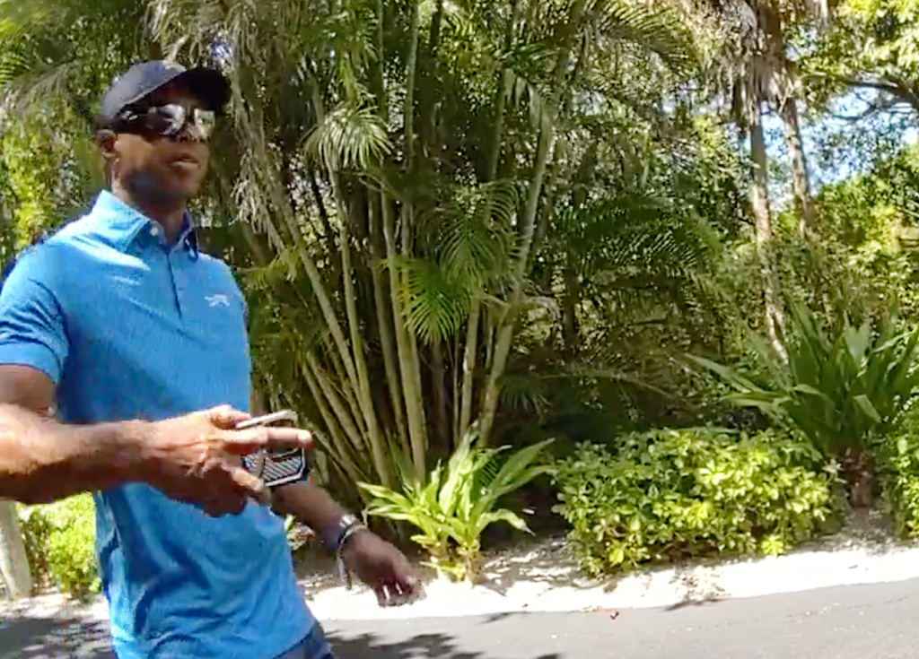 In this image from police body camera video released by the Martin County, Fla., Sheriff's Office, golfer Tiger Woods hangs up his cellphone and tells a sheriff deputy “I was just talking to the president" following a car crash in Jupiter Island, Fla., Friday, March 27, 2026. (Martin County Sheriff's Office via AP)