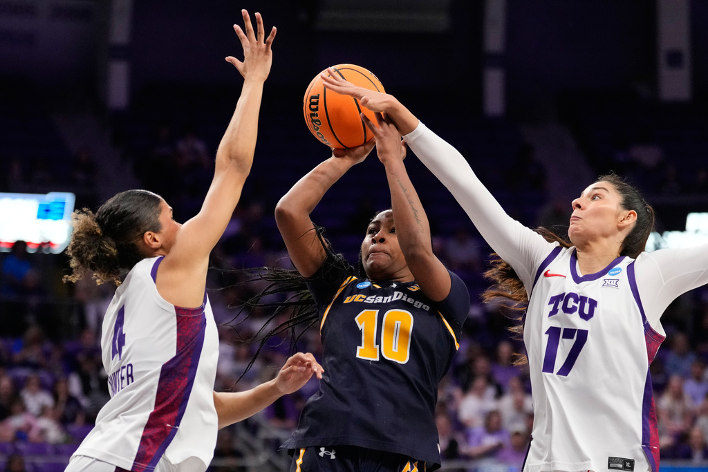 UC San Diego guard Dymonique Maxie (10) shoots as TCU's Donovyn Hunter (4) and Clara Silva (17) defend in the first half in the first round of the NCAA college basketball tournament against, Friday, March 20, 2026, in Fort Worth, Texas. (AP Photo/Tony Gutierrez)
