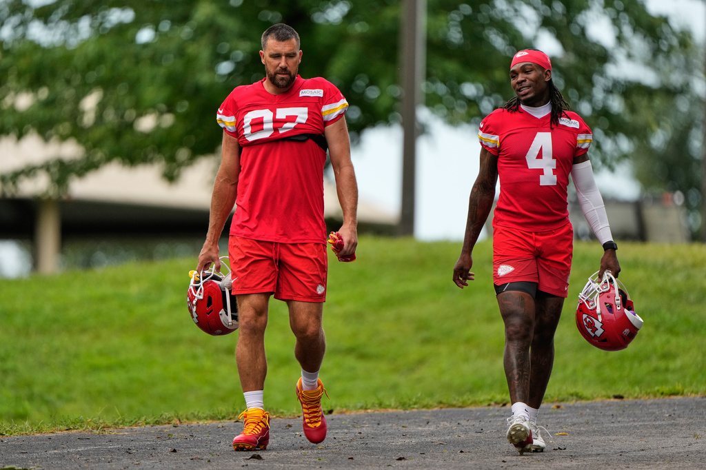 Kansas City Chiefs tight end Travis Kelce (87), and wide receiver Rashee Rice (4) walk to NFL football training camp Friday, July 31, 2026, in St. Joseph, Mo. (AP Photo/Charlie Riedel)