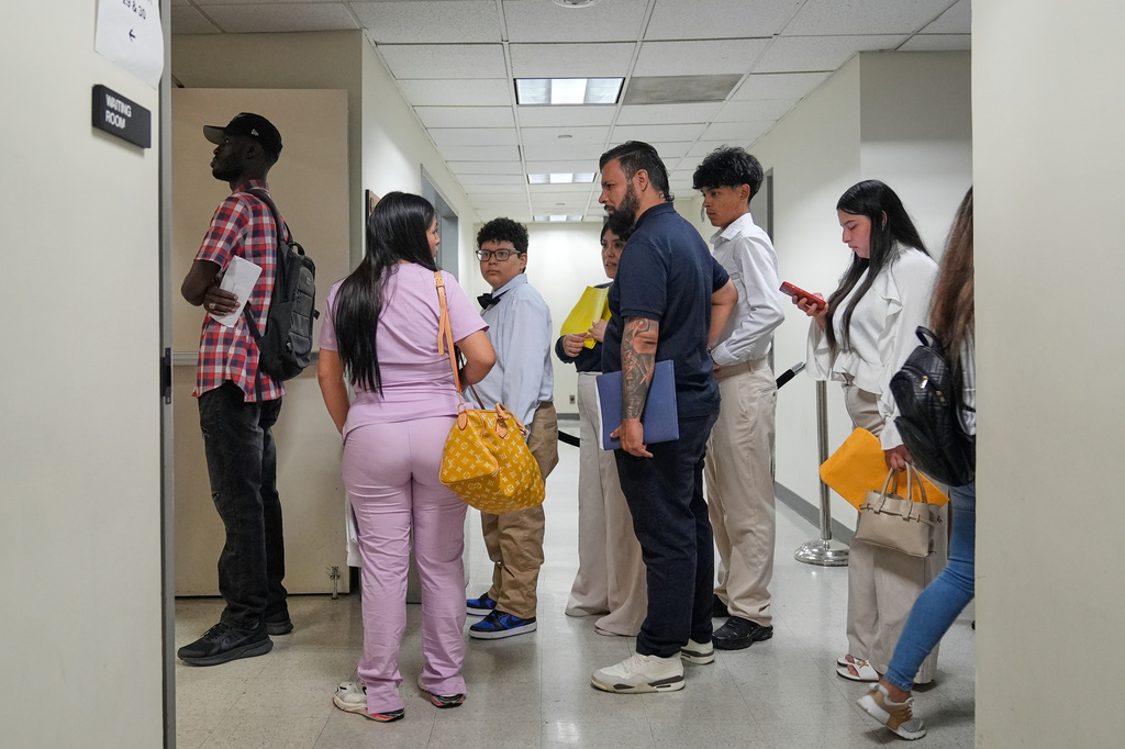 People stand in line for immigration court in New York, Monday, July 27, 2026. (AP Photo/Seth Wenig)