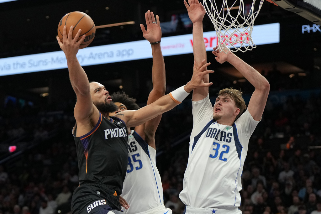 Phoenix Suns forward Dillon Brooks shoots over Dallas Mavericks forward Marvin Bagley III and forward Cooper Flagg (32) during the second half of an NBA basketball game, Tuesday, Feb. 10, 2026, in Phoenix. (AP Photo/Rick Scuteri)