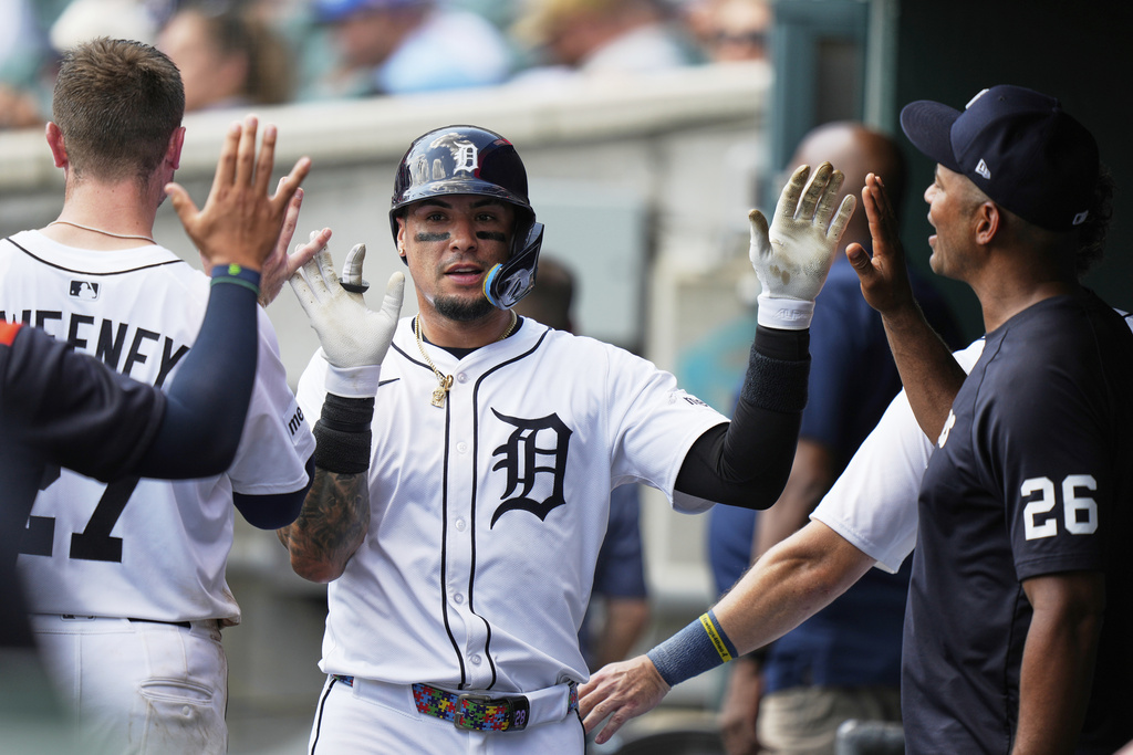 Detroit Tigers' Javier Baez celebrates in the dugout after scoring off of a single hit by Gleyber Torres during the fourth inning of a baseball game against the Los Angeles Angels, Sunday, Aug. 10, 2025, in Detroit. (AP Photo/Ryan Sun)