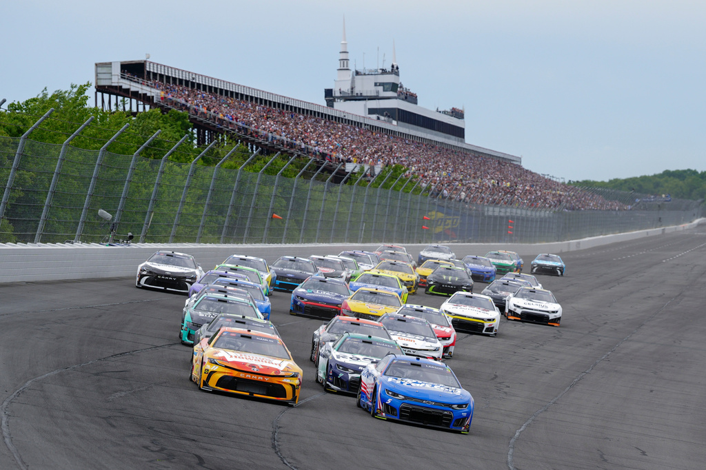 Denny Hamlin (11) and Kyle Larson (5) lead the field during the NASCAR Cup Series auto race at Pocono Raceway, Sunday, June 14, 2026, in Long Pond, Pa. (AP Photo/Derik Hamilton)