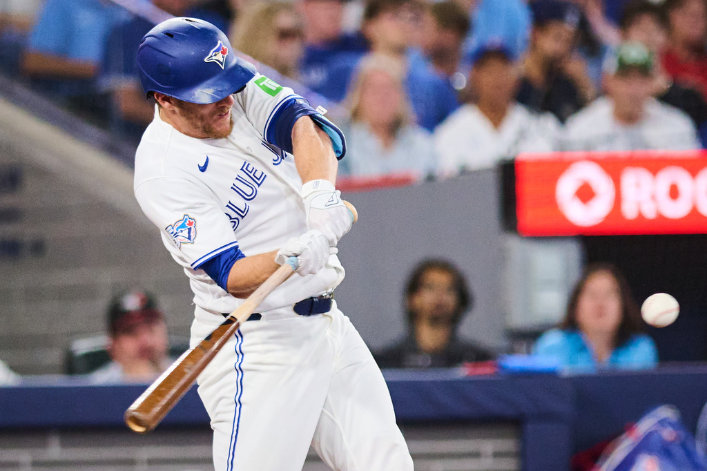 Toronto Blue Jays' Myles Straw (3) hits an RBI double against the Boston Red Sox during eighth inning MLB baseball action in Toronto, on Tuesday, Aug. 11, 2026. (Sammy Kogan/The Canadian Press via AP)