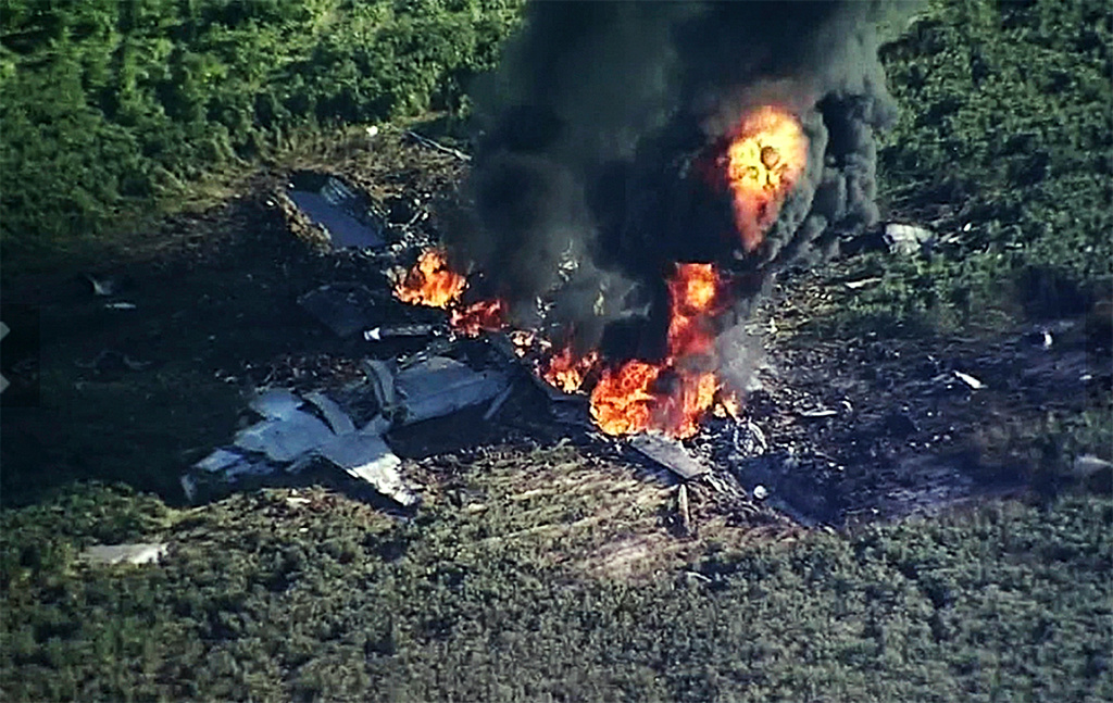 FILE - In this July 10, 2017, file image made from video provided by WLBT-TV, smoke and flames rise from a military plane that crashed in a farm field in Itta Bena, Miss. (WLBT-TV via AP, File)