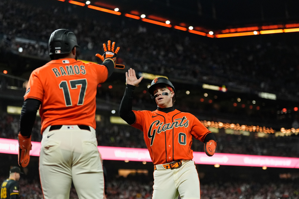 San Francisco Giants' Drew Gilbert (0) celebrates with Heliot Ramos (17) after scoring against the Pittsburgh Pirates on Luis Arraez's single during the seventh inning of a baseball game Friday, May 8, 2026, in San Francisco. (AP Photo/Godofredo A. Vásquez)