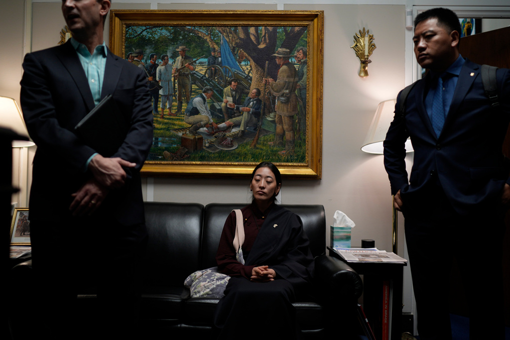 Namkyi, right, a Tibetan former political prisoner who was arrested at 15 for protesting Chinese rule, waits in the office of House Foreign Affairs Committee Chairman Michael McCaul, R-Texas, for a meeting with his staff while joined by Tsultrim Gyatso, right, China Director at Office of Tibet, in Washington, Oct. 8, 2025. (AP Photo/David Goldman)