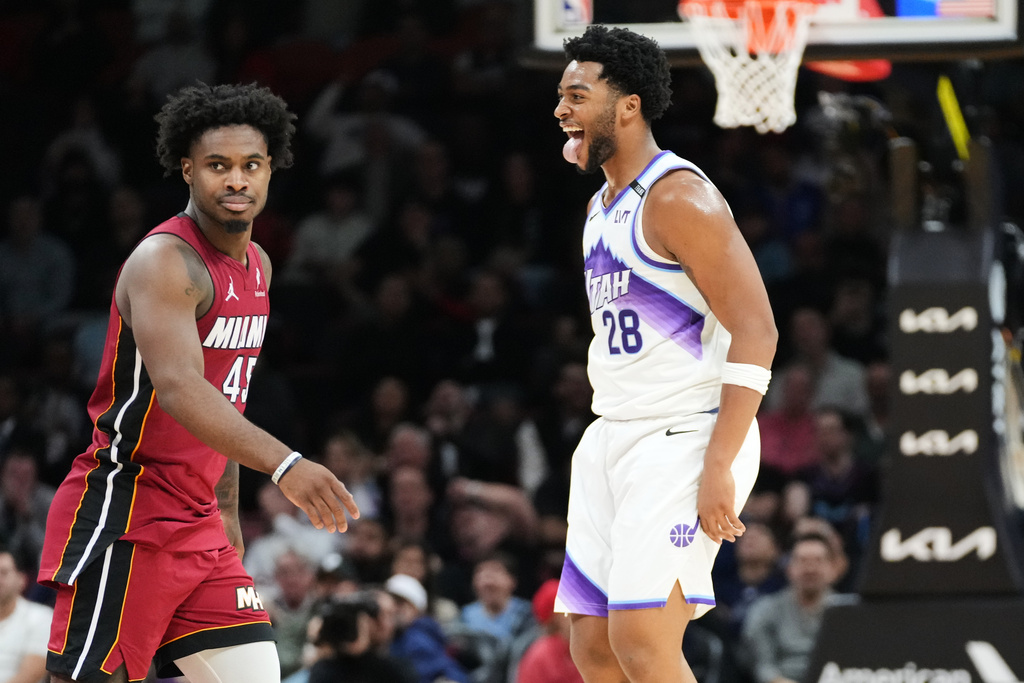Utah Jazz forward Brice Sensabaugh (28) gestures to Miami Heat guard Davion Mitchell (45) after scoring a three-point basket during the second half of an NBA basketball game Monday, Feb. 9, 2026, in Miami. (AP Photo/Marta Lavandier)