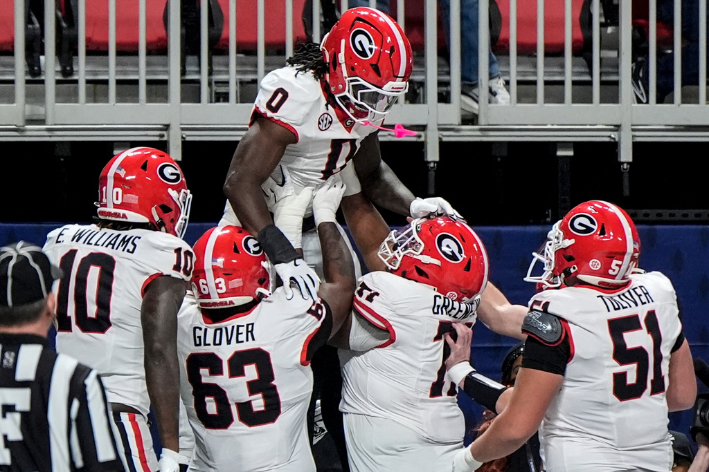 Georgia running back Roderick Robinson II (0) celebrates his touchdown against Alabama during the first half of a Southeastern Conference championship NCAA college football game, Saturday, Dec. 6, 2025, in Atlanta. (AP Photo/Mike Stewart)