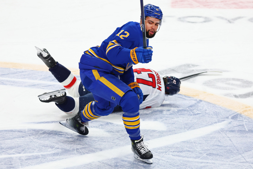Buffalo Sabres Jordan Greenway checks Washington Capitals defenseman Declan Chisholm (47) during the first period of an NHL hockey game Saturday, Nov. 1, 2025, in Buffalo, N.Y. (AP Photo/Jeffrey T. Barnes)