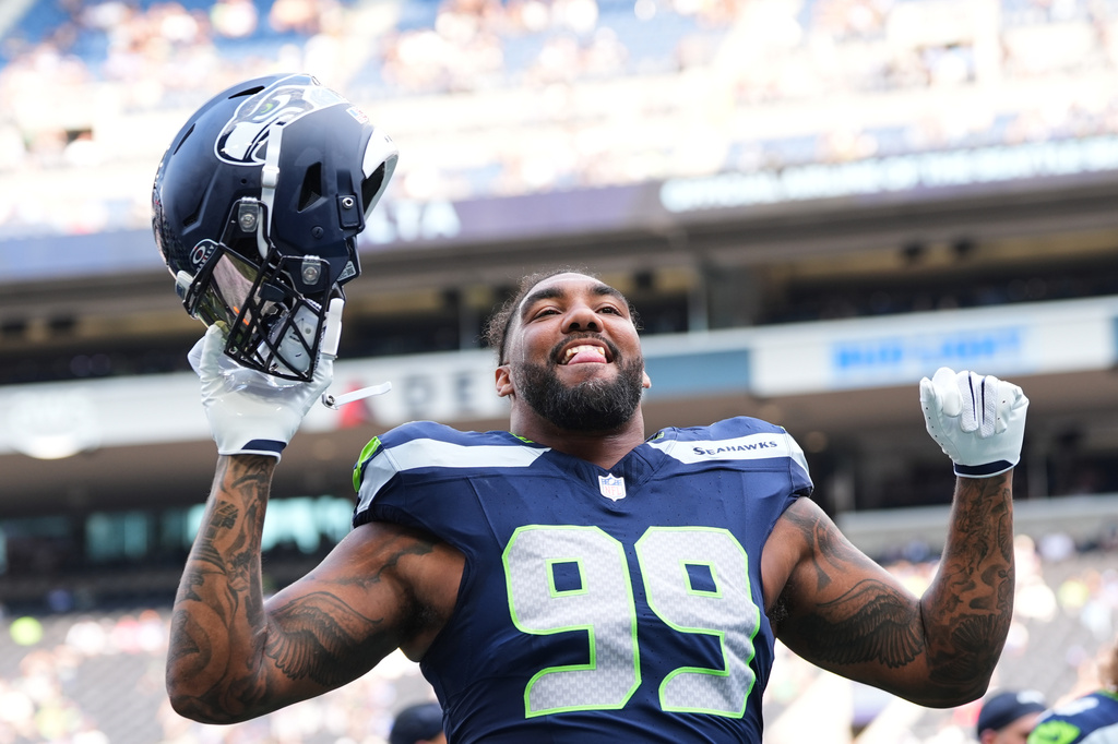 Seattle Seahawks' Leonard Williams responds to fans during warmups before an NFL preseason football game against the Dallas Cowboys, Saturday, Aug. 15, 2026, in Seattle. (AP Photo/Lindsey Wasson)