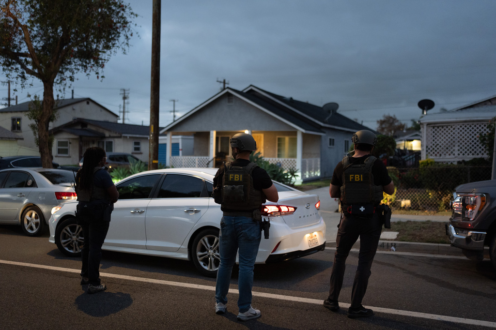 FBI agents take positions outside the home of Lakiya Malone, who is charged with fraud involving federal homelessness aid programs, in Los Angeles, Wednesday, Sept. 16, 2026. (AP Photo/Jae C. Hong)