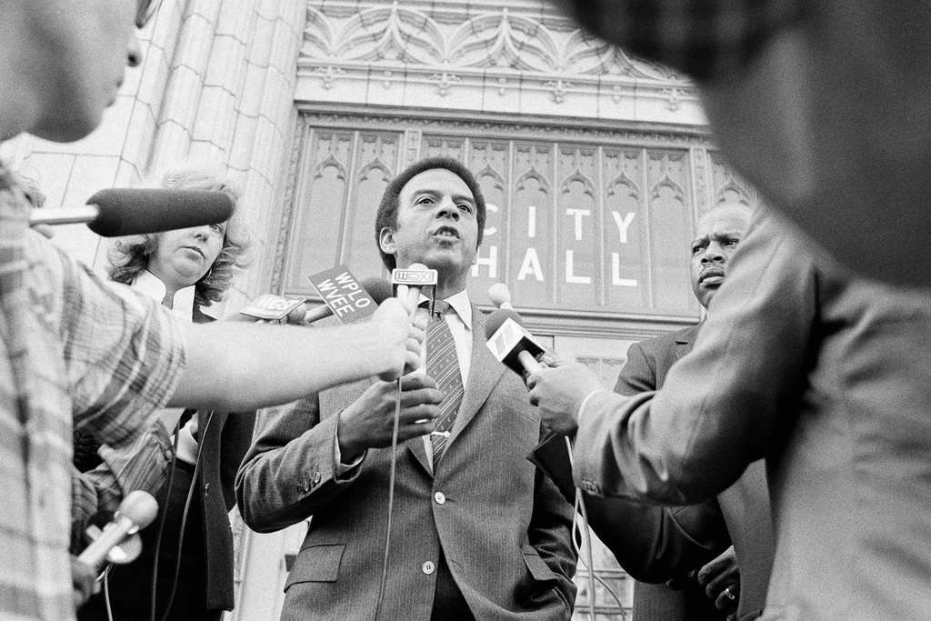 FILE - Atlanta Mayor Andrew Young talks to the media on the steps of City Hall, Nov. 10, 1982, in Atlanta. At right is City Councilman John Lewis. (AP Photo/Charles Kelly, File)