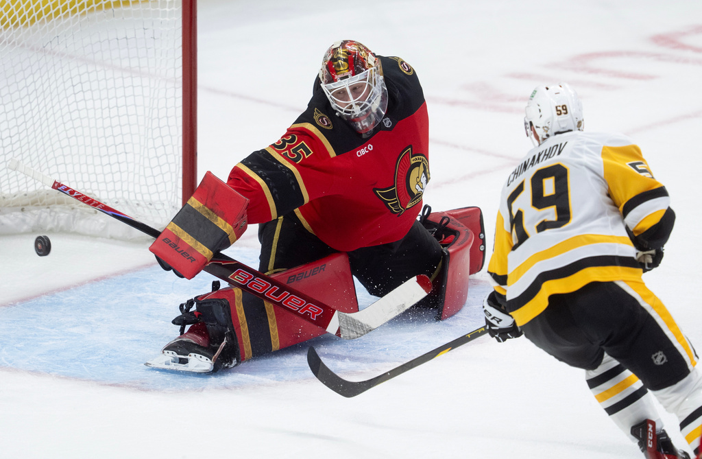 Pittsburgh Penguins Egor Chinakhov (59) pressures Ottawa Senators goaltender Linus Ullmark (35) as the puck goes wide of the net during the second period of an NHL game in Ottawa, Thursday, March 26, 2026. (Adrian Wyld/The Canadian Press via AP)