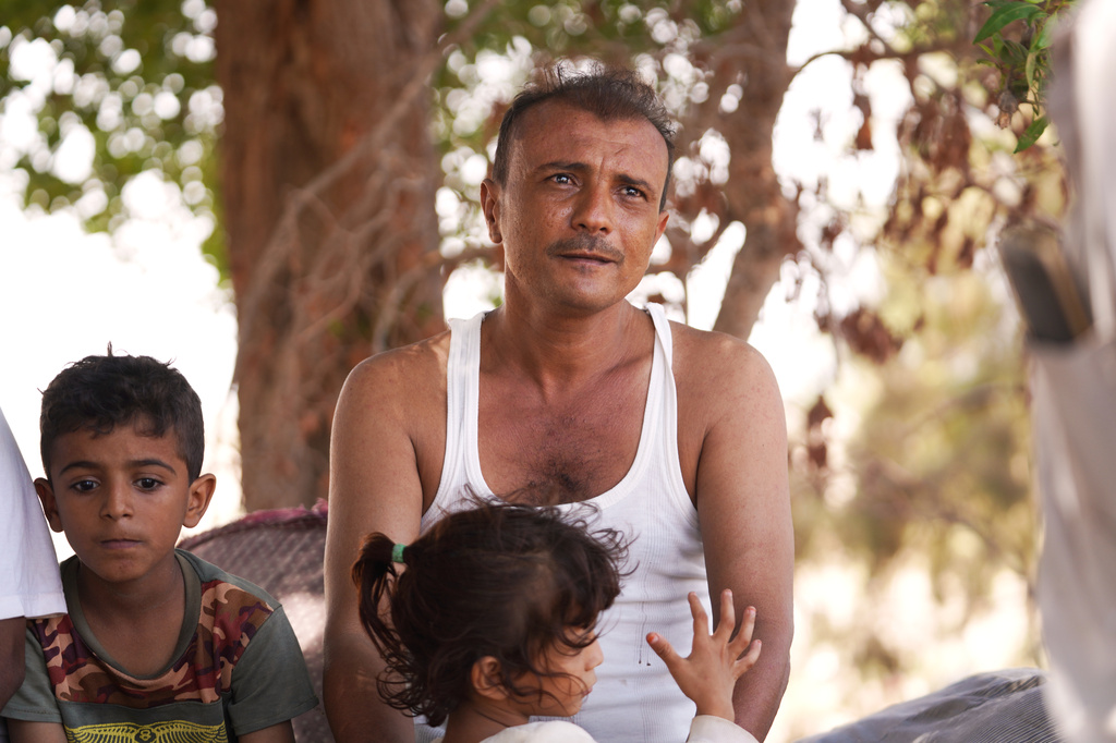 Displaced Yemenis, from Al Khawkhah city, 400 kilometers (249 miles) south west of Sanaa, wait to enter a temporary shelter in Aden, Yemen, Sunday, Sept. 13, 2026. (AP Photo/Abdulnasser Alseddik)