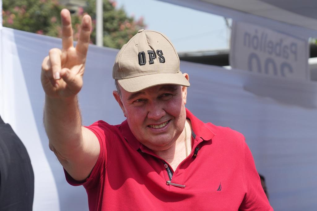 Rafael Lopez Aliaga, presidential candidate of the Popular Renewal party, makes a victory sign at a polling station during general elections in Lima, Peru, on Sunday, April 12, 2026. (AP Photo/Guadalupe Pardo)