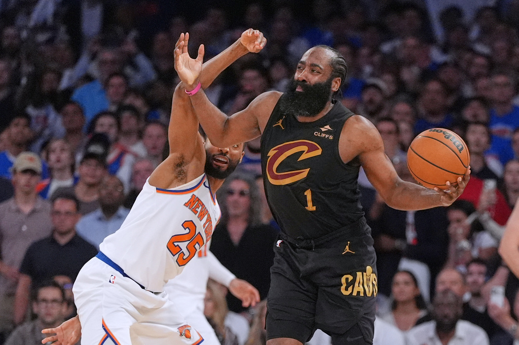 New York Knicks' Mikal Bridges, left, covers Cleveland Cavaliers' James Harden during the overtime period of Game 1 in the Eastern Conference finals NBA basketball playoffs series Tuesday, May 19, 2026, in New York. (AP Photo/Seth Wenig)