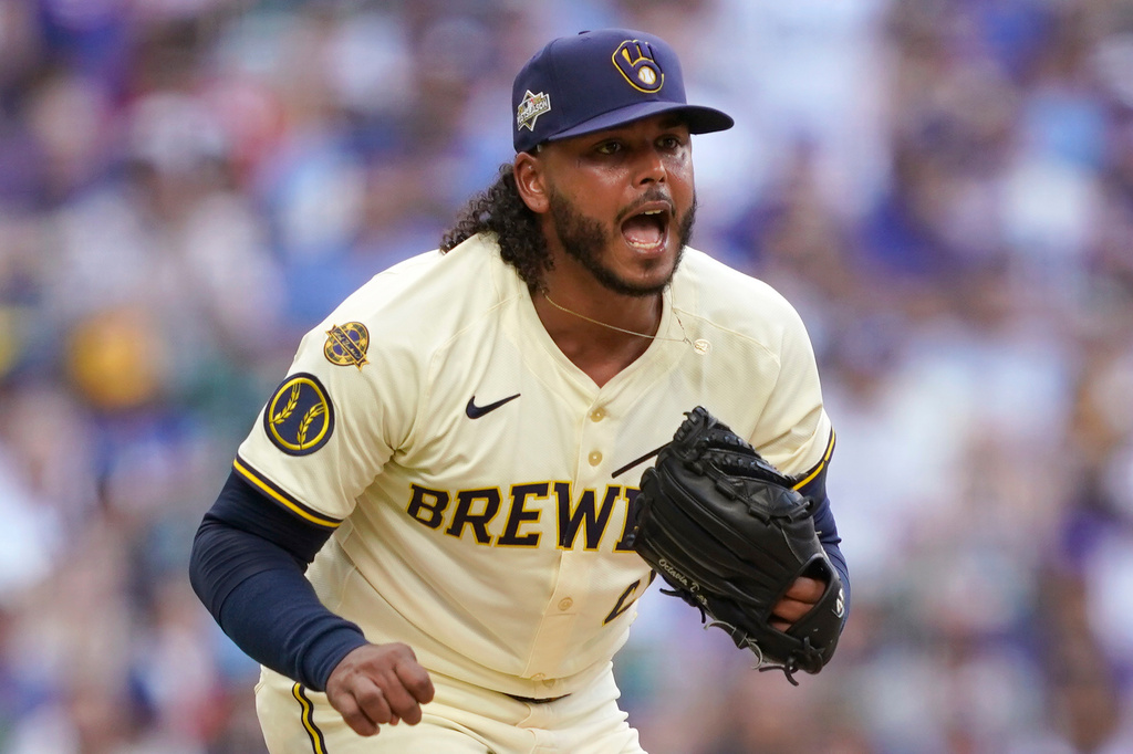 Milwaukee Brewers pitcher Freddy Peralta (51) reacts to striking out a batter during the fifth inning in Game 1 of baseball's National League Division Series against the Chicago Cubs on Saturday, Oct. 4, 2025, in Milwaukee. (AP Photo/Kayla Wolf)