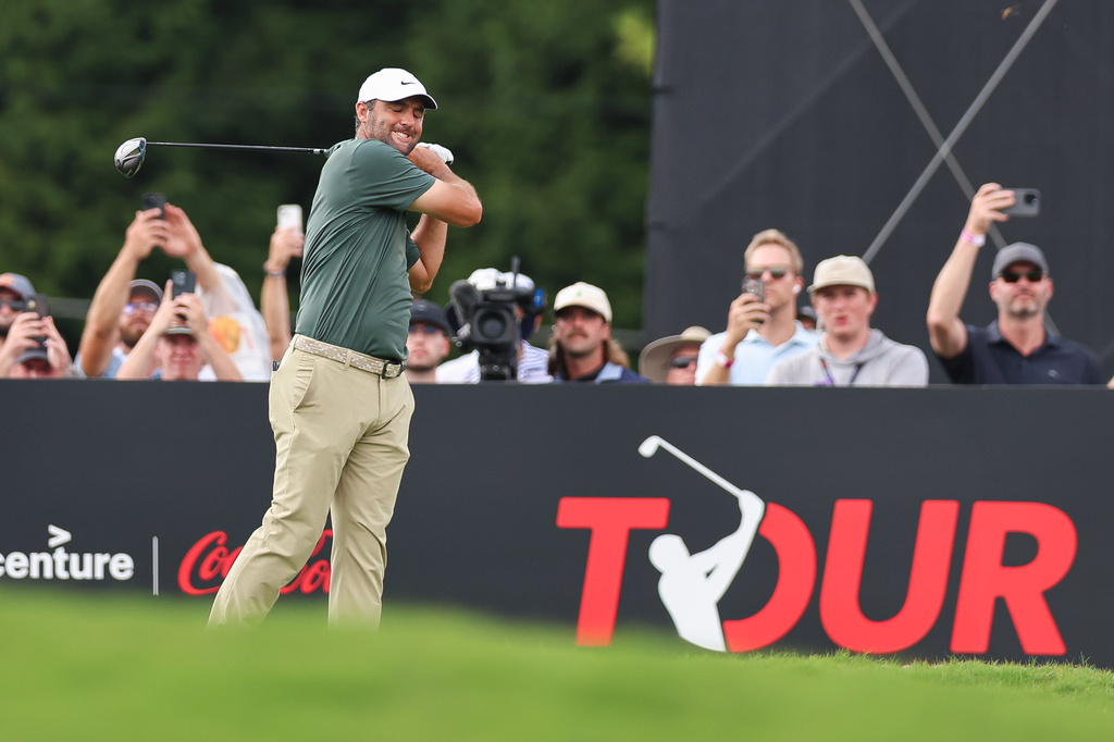 Scottie Scheffler reacts after playing his tee shot on the 18th hole during the second round of the Tour Championship golf tournament, Friday, Aug. 28, 2026, in Atlanta. (AP Photo/Colin Hubbard)