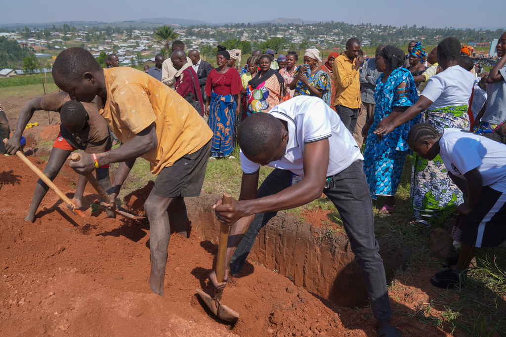 Workers after a burial ceremony cover the grave of Neema Minaro, a 66 year old woman who died of the Ebola virus, in Bunia, Congo, Wednesday, Sept. 2, 2026. (AP Photo/Dieudonne Dirole)