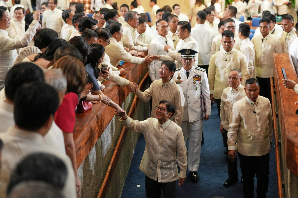 Philippine President Ferdinand Marcos Jr. , center, shakes hands after he delivers his 5th State of the Nation Address at the House of Representatives on Monday July 27, 2026 in Quezon city, Philippines. (AP Photo/Aaron Favila)