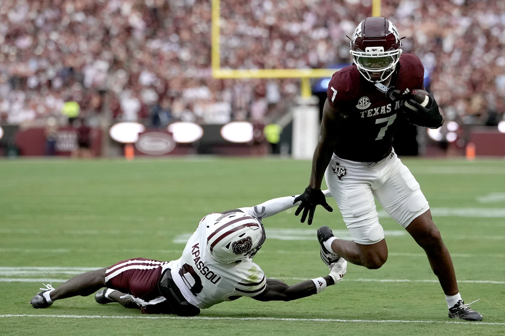 Texas A&M wide receiver Isaiah Horton (7) breaks free from a tackle attempt by Missouri State cornerback Joel Kpassou (8) for a touchdown run during the first quarter of an NCAA college football game Saturday, Sept. 5, 2026, in College Station, Texas. (AP Photo/Sam Craft)
