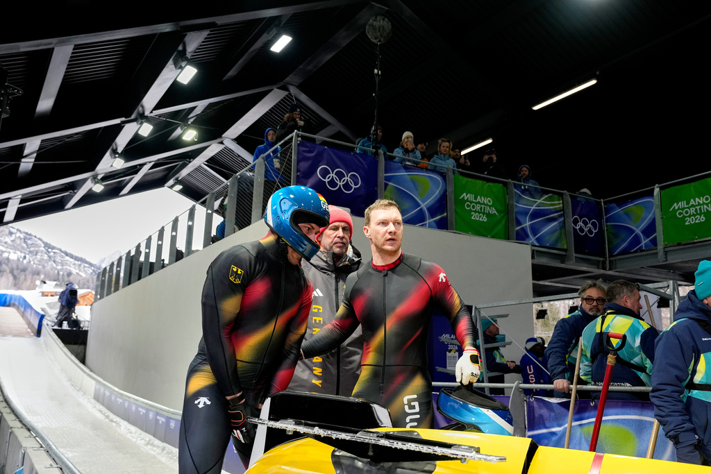 Germany's Francesco Friedrich, center right, arrives at the finish during a four man bobsled run at the 2026 Winter Olympics, in Cortina d'Ampezzo, Italy, Saturday, Feb. 21, 2026. (AP Photo/Alessandra Tarantino)