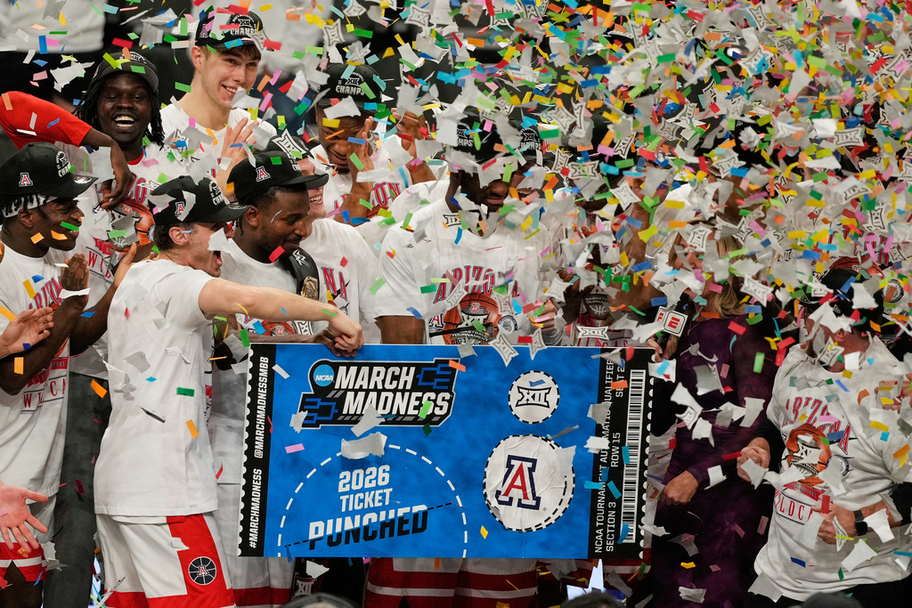 Arizona players celebrate after winning an NCAA college championship basketball game against Houston at the Big 12 Conference tournament Saturday, March 14, 2026, in Kansas City, Mo. (AP Photo/Charlie Riedel)