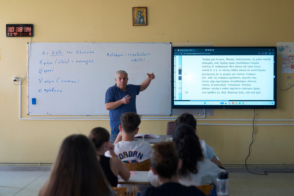 Teacher Filippos Mantzaris leads a lesson on Homer's Odyssey for seventh-grade students at a Gymnasio (middle school) in the Athens suburb of Tavros, Wednesday, May 27, 2026. (AP Photo/Petros Giannakouris)