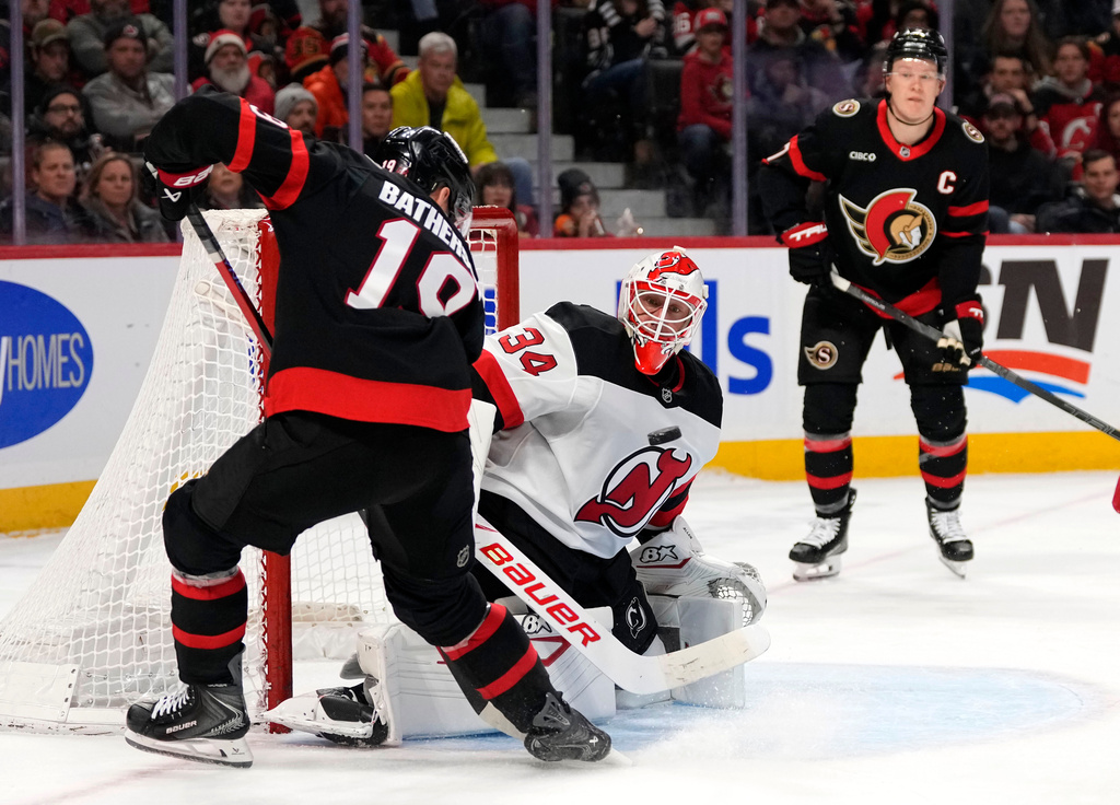 Ottawa Senators' Drake Batherson (19) looks for a chance against New Jersey Devils goaltender Jake Allen (34) during the second period of an NHL hockey game in Ottawa, on Saturday, Jan. 31, 2026. (Justin Tang/The Canadian Press via AP)