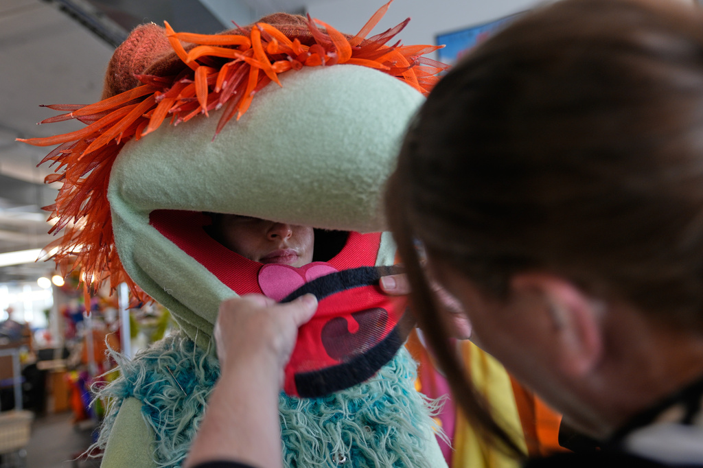 Sarah Lafferty, right, fits a mouthpiece on "Boober," a character in the "Jim Henson's Fraggle Rock: Back to the Rock Live" show, at Jim Henson's Creature Shop in New York, Wednesday, May 13, 2026. (AP Photo/Seth Wenig)
