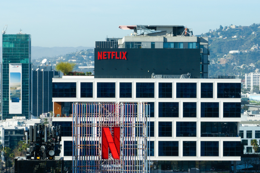 A Netflix sign and the company's logo are displayed atop buildings in Los Angeles, Thursday, Dec. 18, 2025. (AP Photo/Jae C. Hong)