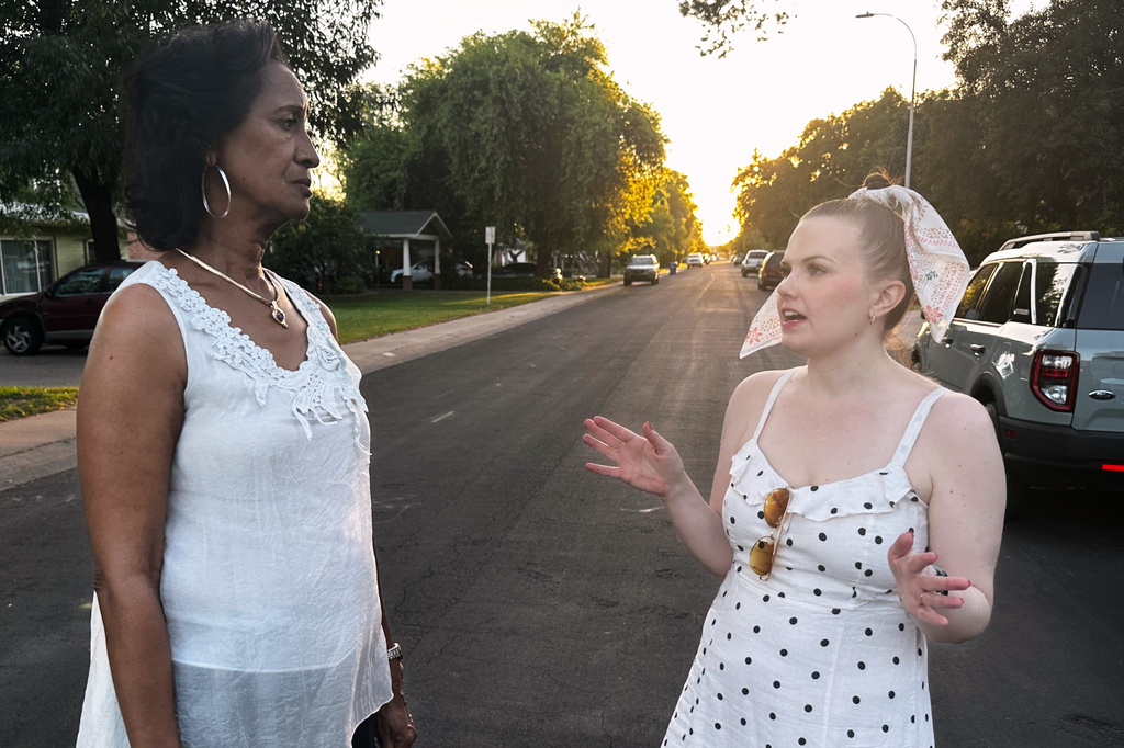 Sandra Kennedy, left, and Casey Clowes, candidates for the Salt River Project governor board, speak while canvassing in Tempe, Ariz., on Wednesday, April 1, 2026. (AP Photo/Jonathan J. Cooper)