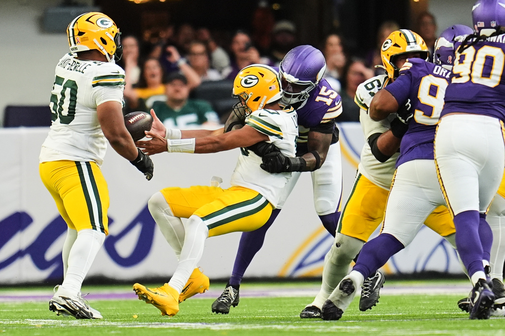 Green Bay Packers quarterback Jordan Love (10) fumbles the ball after being hit by Minnesota Vikings linebacker Dallas Turner (15) during the second half of an NFL football game, Sunday, Sept. 13, 2026, in Minneapolis, Minn. (AP Photo/Abbie Parr)