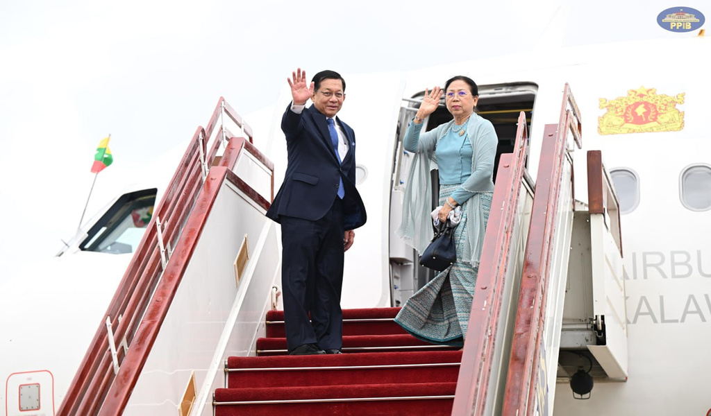 In this photo released by Myanmar President Office, Myanmar President Min Aung Hlaing, left, and his wife Kyu Kyu Hla wave upon his departure to Vietnam, at the Naypyitaw international airport Friday, Sept. 4, 2026, in Naypyitaw, Myanmar. (Myanmar President Office via AP)