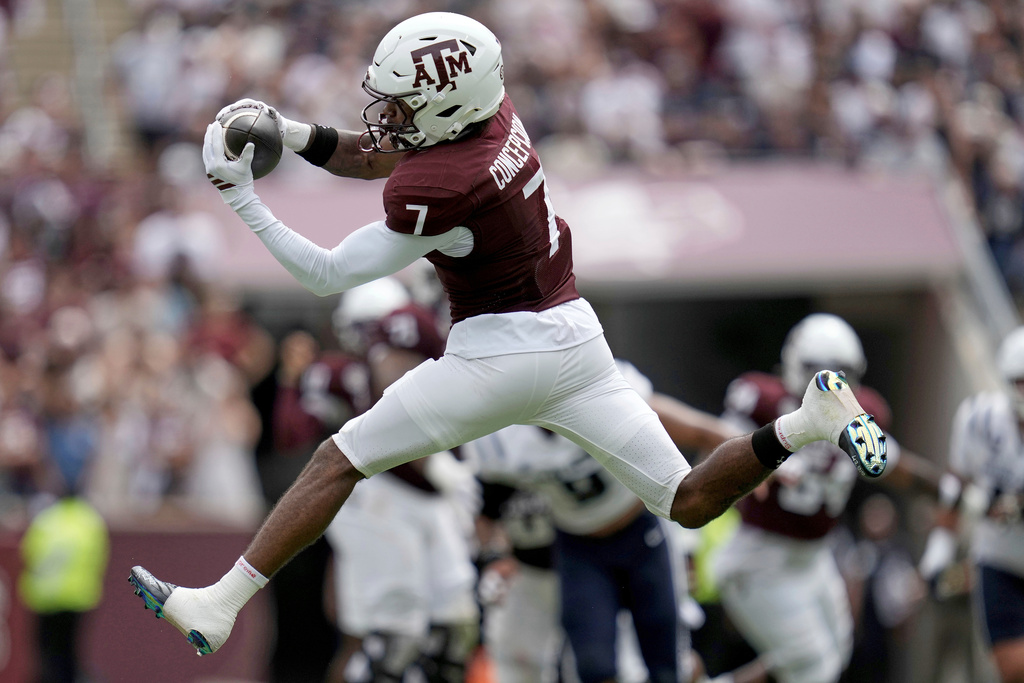 Texas A&M wide receiver KC Concepcion (7) makes a leaping catch for a first down against Utah State during the first quarter of an NCAA college football game Saturday, Sept. 6, 2025, in College Station, Texas. (AP Photo/Sam Craft)