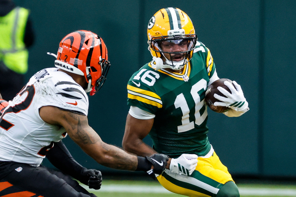 Green Bay Packers' Bo Melton (16) runs agaimnst Cincinnati Bengals safety Geno Stone (22) in the second half of an NFL football game, Sunday, Oct. 12, 2025, in Green Bay, Wis. (AP Photo/Mike Roemer)