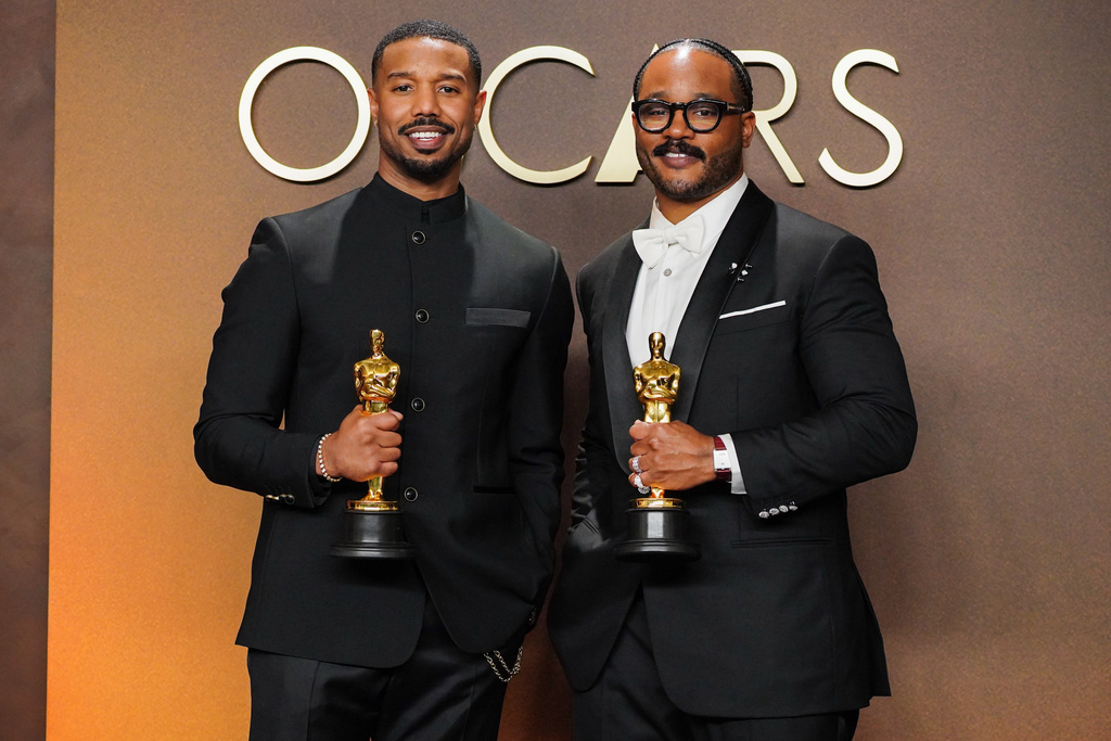 Michael B. Jordan, left, winner of the award for actor in a leading role for "Sinners," and Ryan Coogler, winner of the award for writing (original screenplay) for "Sinners," pose in the press room at the Oscars on Sunday, March 15, 2026, at the Dolby Theatre in Los Angeles. (Photo by Jordan Strauss/Invision/AP)