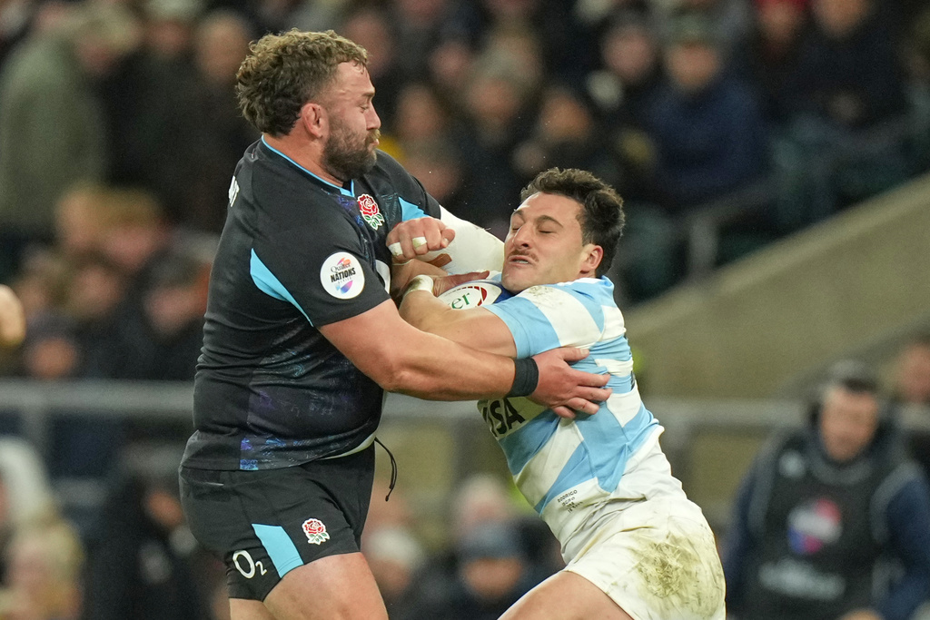 Argentina's Rodrigo Isgro, right, is tackled by England's Will Stuart during the Nation's Series rugby union international between England and Argentina at Twickenham, London, Sunday, Nov. 23, 2025. (AP Photo/Alastair Grant)