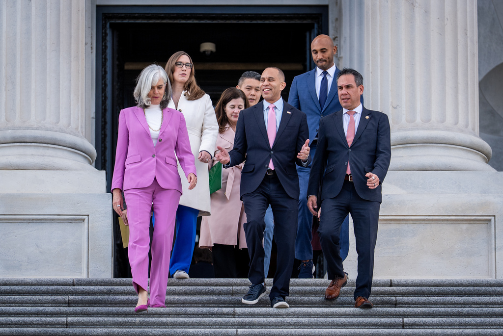 House Minority Leader Hakeem Jeffries, D-N.Y., center, flanked by Rep. Katherine Clark, D-Mass., House minority whip, and Rep. Pete Aguilar, D-Calif., lead fellow Democrats to speak on the health care funding fight on the steps of the House before votes to end the government shutdown, at the Capitol in Washington, Wednesday, Nov. 12, 2025. (AP Photo/J. Scott Applewhite)