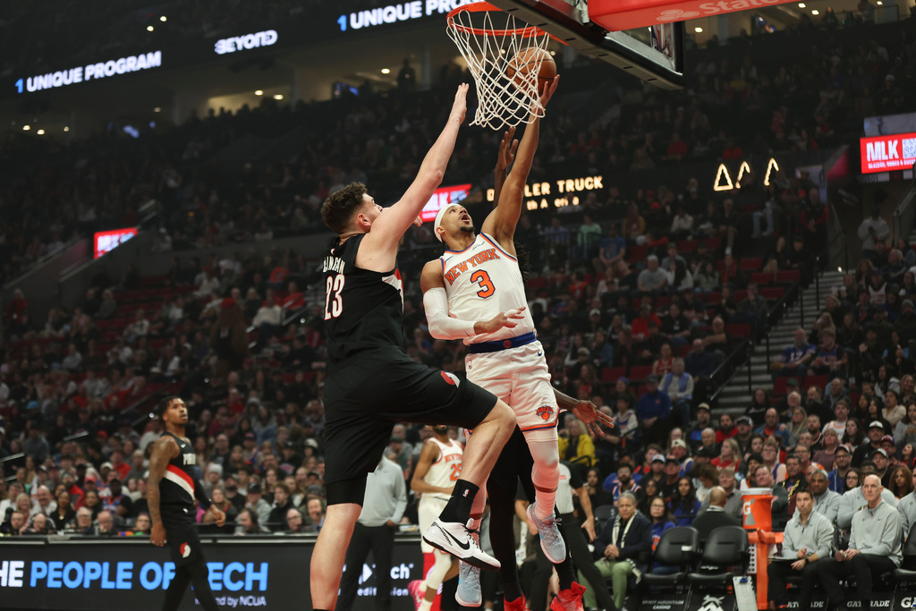 New York Knicks guard Josh Hart (3) drives to the basket as Portland Trail Blazers center Donovan Clingan (23) defends during the first half of an NBA basketball game Sunday, Jan. 11, 2026, in Portland, Ore. (AP Photo/Amanda Loman)