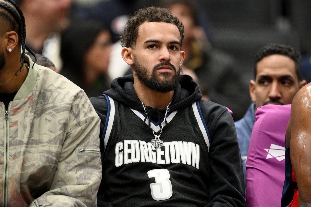 FILE - Washington Wizards guard Trae Young, center, looks on from the bench during the first half of an NBA basketball game against the Los Angeles Clippers, Jan. 19, 2026, in Washington. (AP Photo/Nick Wass, File)