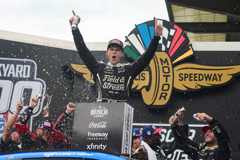 Corey Heim, center, celebrates after winning a NASCAR Cup Series auto race at Indianapolis Motor Speedway in Indianapolis, Sunday, July 26, 2026. (AP Photo/Michael Conroy)