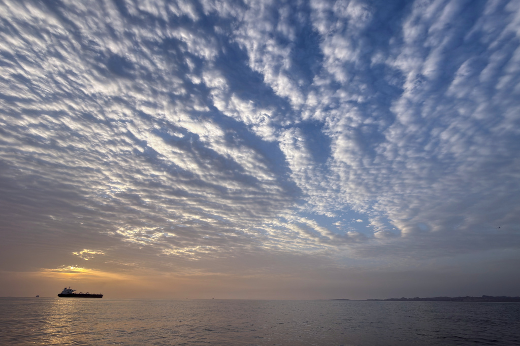 FILE - The sun rises behind a tanker anchored in the Strait of Hormuz off the coast of Qeshm Island, Iran, Saturday, April 18, 2026. (AP Photo/Asghar Besharati, File)