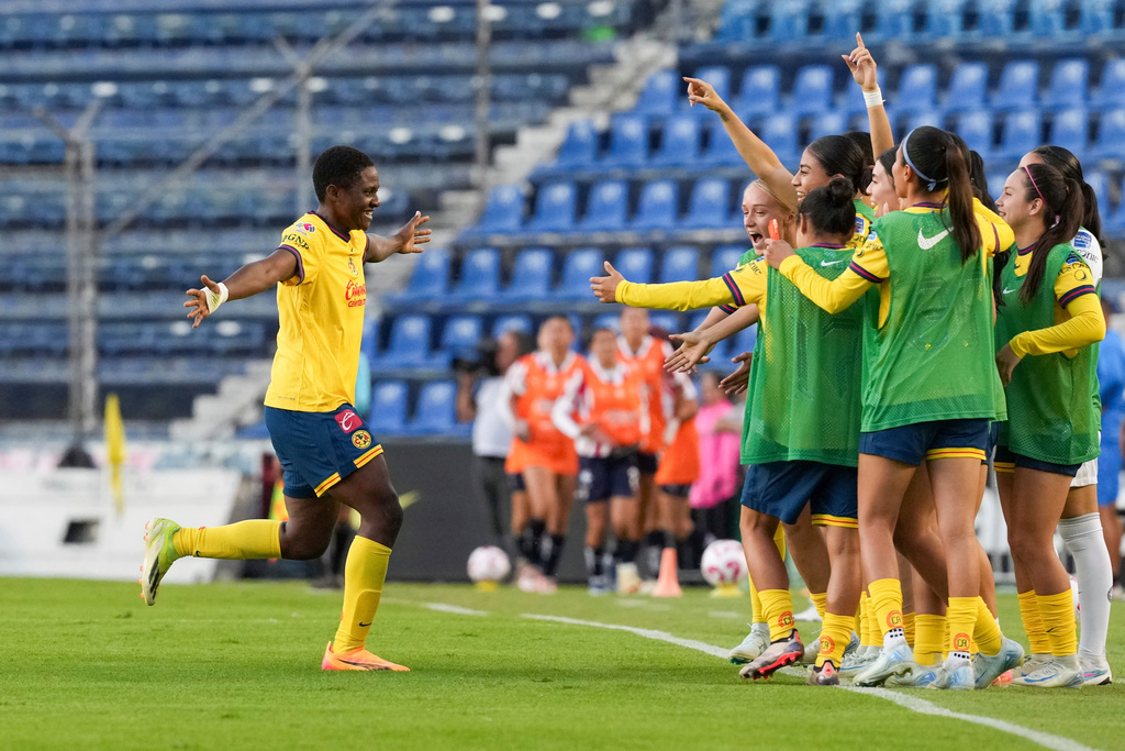 FILE - Club America's Chidinma Okeke, left, celebrates with teammates after scoring the opening goal against Guadalajara during a Mexican women's soccer league quarterfinal second leg match in Mexico City, Monday, Nov. 11, 2024. (AP Photo/Eduardo Verdugo, File)