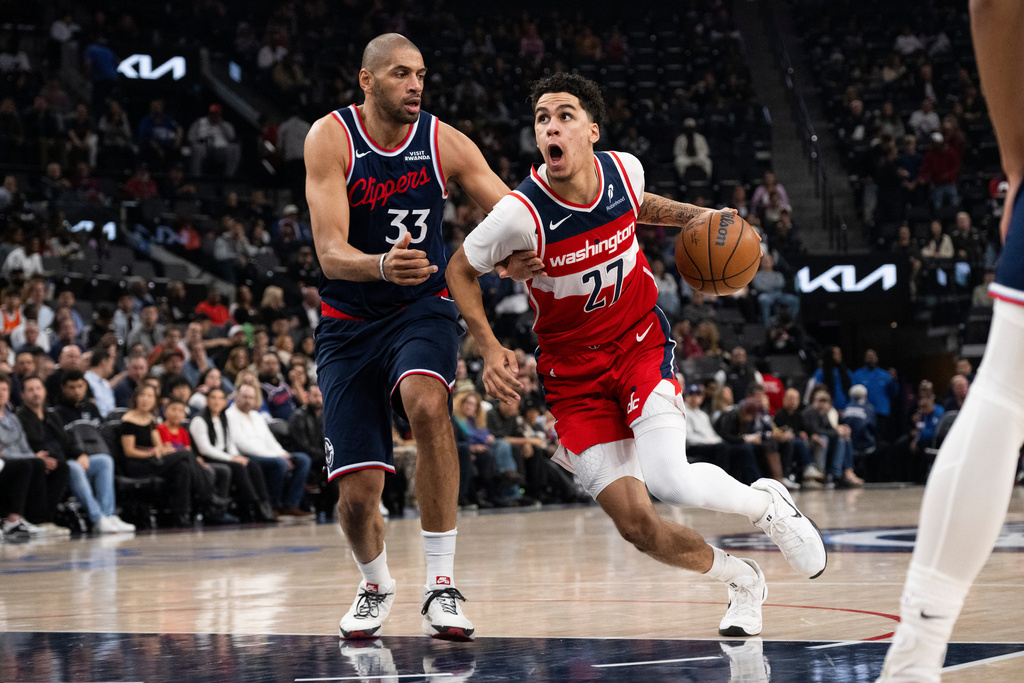 Washington Wizards guard Will Riley (27) drives to the basket as Los Angeles Clippers forward Nicolas Batum (33) defends during the first half of an NBA basketball game Wednesday, Jan. 14, 2026, in Inglewood, Calif. (AP Photo/Kyusung Gong)