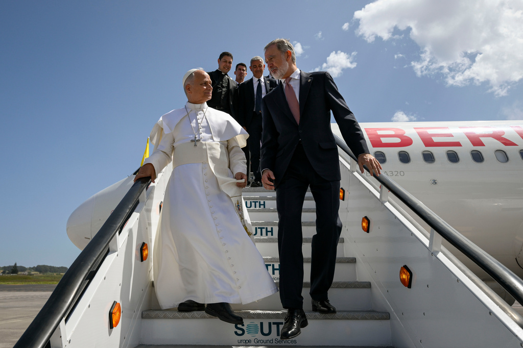 In this handout photo provided by Vatican Media, Pope Leo XIV is accompanied by King Felipe VI of Spain as he deplanes after a technical problem at Tenerife Norte-Los Rodeos International Airport in Tenerife, Spain, Friday, June 12, 2026. (Vatican Media via AP)